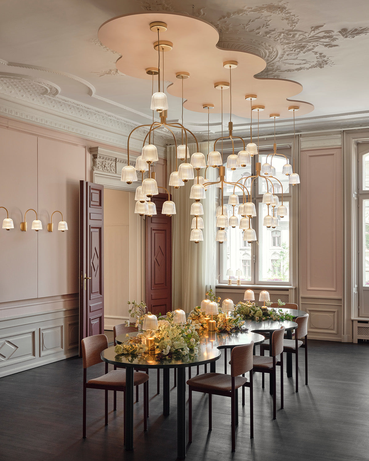 Nuura Showroom exhibtion with Asteea lighting installation above a long table during 3daysofdesign in Copenhagen.