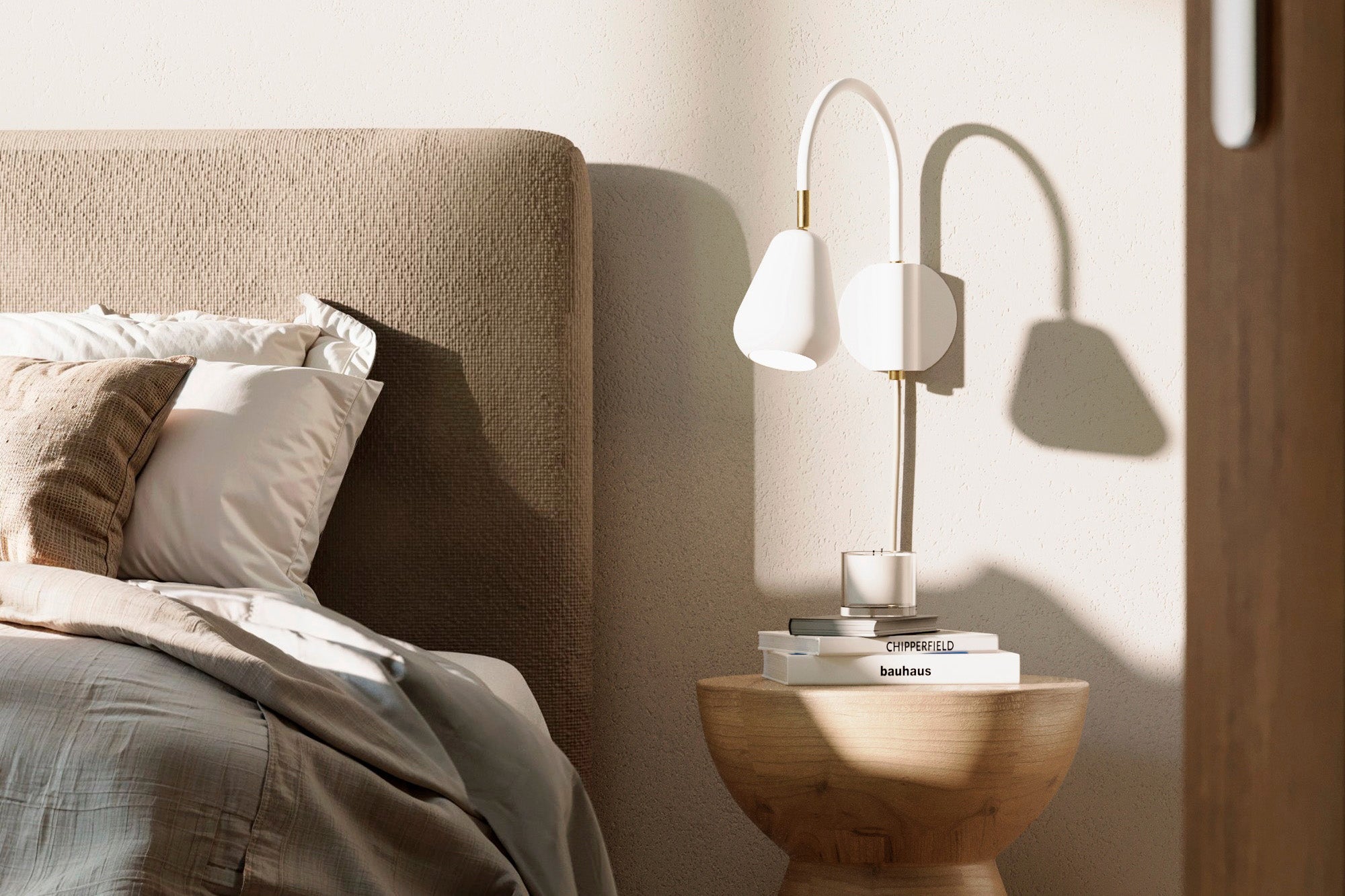 Anoli Spot Wall bedside lamp in a bedroom scene with a bed and wooden nightstand.